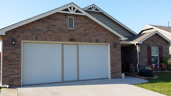16x7 Lifestyle Garage door Screen with sandstone color frame and white privacy screen.
