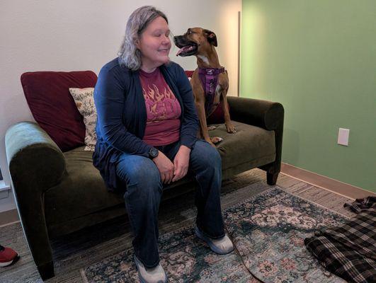 Ruby hanging out on the couch with her owner after her therapy session