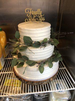 3 tier white wedding cake. (topper and greenery added after purchase) Beautiful minimalist design by sweet art.