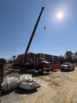 Setting CLT roof panels on a new gas station construction
