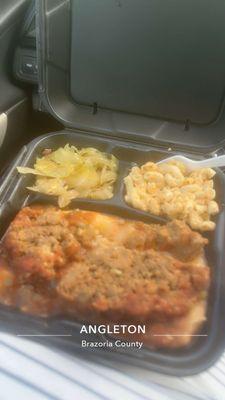 Meatloaf over mashed potatoes cabbage and macaroni and cheese