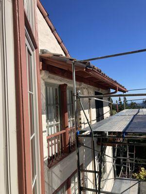 Scaffolding to reach roof tiles, gutters (to repair and add screening), and paint eaves.