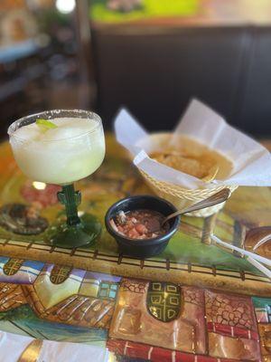 Frozen margarita with chips and salsa.