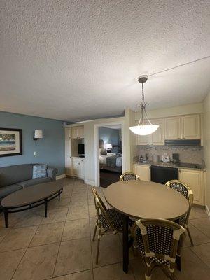 Room #102. Large spacious lounge with 2 sofas and TV, dining table, kitchen with coffee machine, microwave and fridge