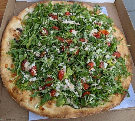 Arugula salad on mushroom & pepper pizza.
