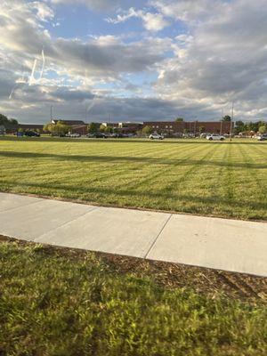 school with grass and sidewalk