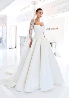 Estelle (3564). Timeless Clean strapless neckline, full satin ballgown skirt, and a matching lace veil for a romantic finish.