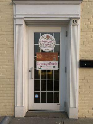 Front door with business names on it.