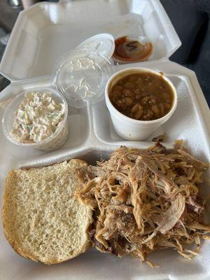 Pulled pork bbq sandwich with coleslaw and beans with sweet bbq sauce