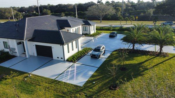 New 5700 sqft concrete driveway installation with artificial turf.