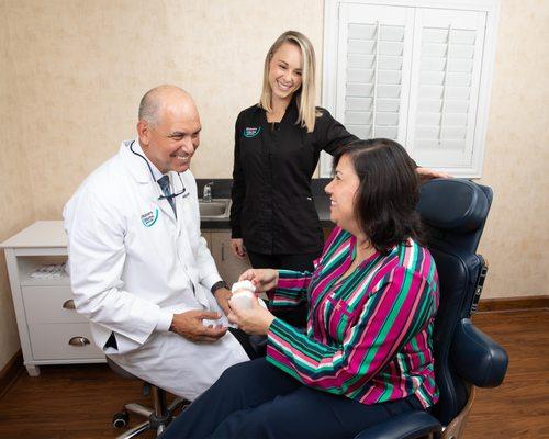 Dr. Timothy Muscaro talks with a patient about treatment options for TMJ