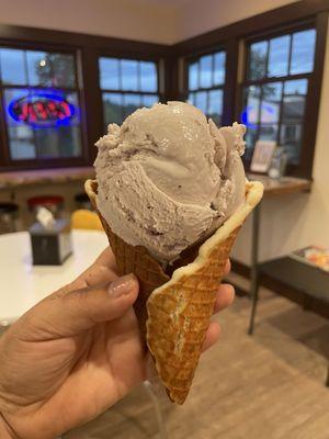 Huckleberry ice cream in a homemade waffle cone.