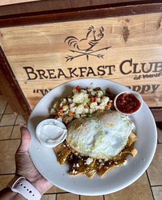 Green Chilaquiles, over medium eggs, Club potatoes and Homemade salsa with sour cream.
