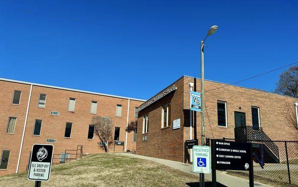 Early learning center to right front and Elementary & middle to rear