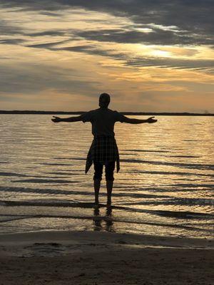 Body silhouette over looking the sun setting on the albemarle sound. Photography by Kimberly Burford