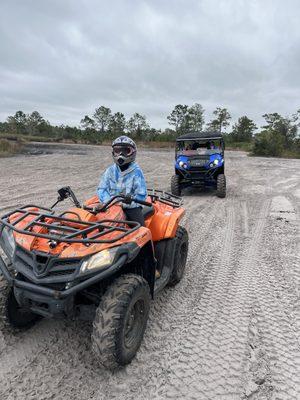 Kids riding ATVs in the forest trails