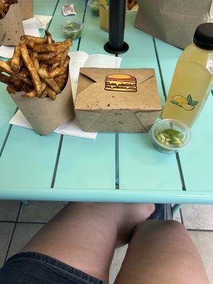 Fries cooked in beef tallow. The cheeseburger is in the box. The drink is lemonade made with likes, honey, and purified water