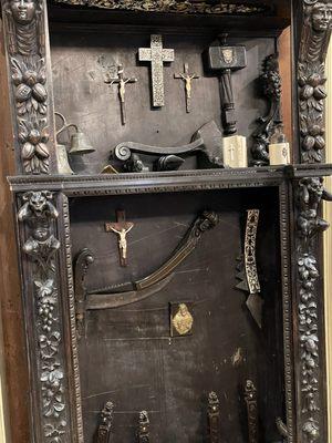 Box of crosses and weapons