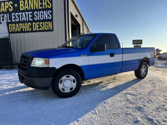 We recently transformed a white F-150 by applying a sleek blue wrap with custom stripes, resulting in a striking new look.