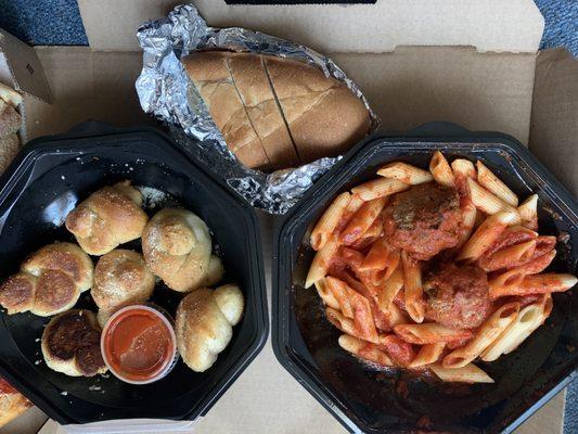 Penne with meatballs, garlic knots, bread.