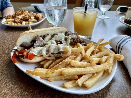Philly Cheese Steak: shaved prime rib, grilled onions and peppers topped with Swiss cheese