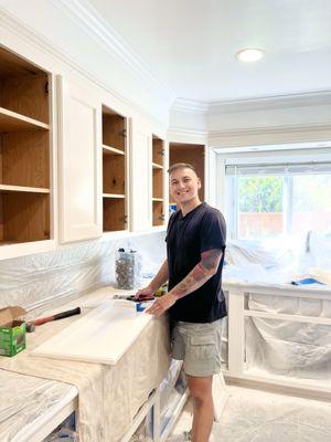 Final stage of this kitchen makeover -- freshly painted and ready for assembly! Spray finish, clean lines, done with care and a smile.