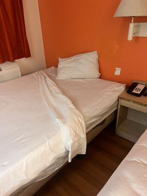 Ripped lamp shade. No blankets. Missing headboard on one of the beds with gouged walls. I felt like I was in a CSI episode.