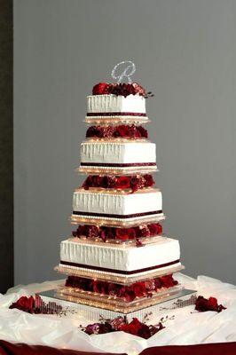 A tall lighted wedding cake