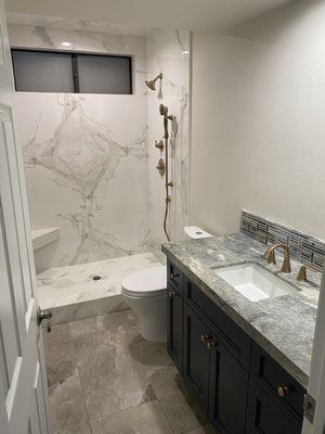 Beautiful shower remodel which included upgraded vanity, enclosure, and toilet. The gold fixtures were a great choice by our customer!