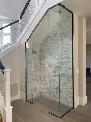 A creative and unique wine enclosure by Distinctive Shower, Glass, and Mirror.