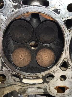 Carbon build up causes low compression/leaky valve. Blue smoke on start up is a sign a valve leaking oil into a cylinder.