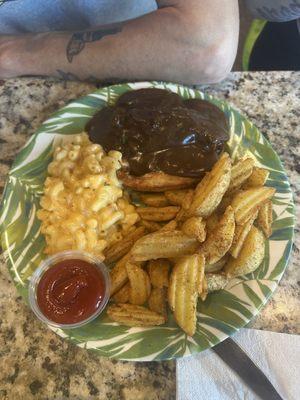 Smothered Chicken with brown gravy, potato wedges, and mac and cheese