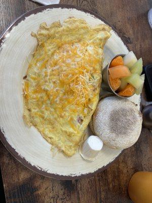 Western omelet with fresh fruit and English muffin.