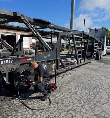 Performing a tire change on a Heavy Duty Commercial Car Hauler. Making sure driver gets back on the road safely!