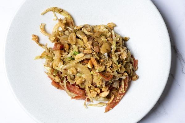 Tea Leaf Salad/Lat Phat Thoat - Crispy pea, peanut, sesame seed, garlic oil, ground pickle tea leaf, cabbage, & tomato