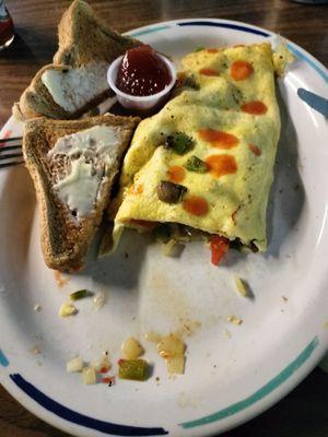 Three egg vegetable omelette with whole wheat toast (hot sauce added).