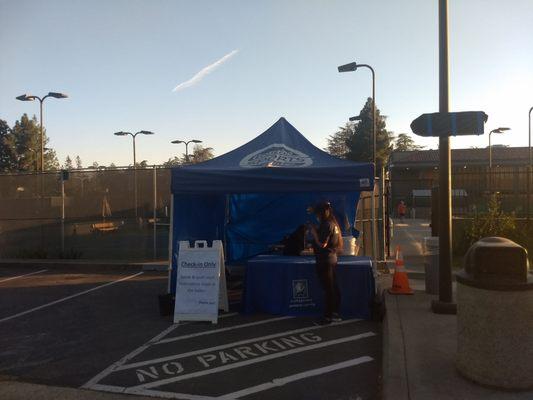 tennis check in tent for CTC members, You can see the boarded up windows of the main building closed due to construction.