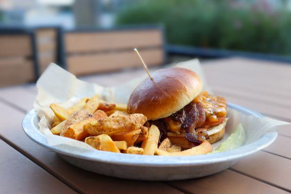 Quarter pound char grilled burger, sweet peppered bacon, cheddar cheese, lettuce, tomato, and Sriracha aioli.