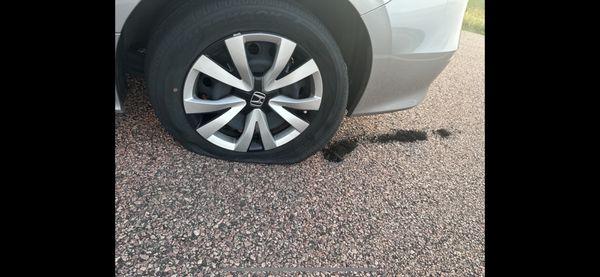 Tire still on car with debris