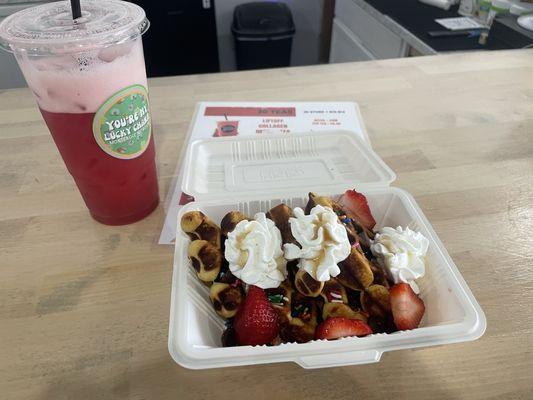 Glinda energy tea and birthday cake protein waffles with whipped cream, chocolate chips, and strawberries