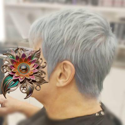 A razored pixie and double process toned with Redken Shades EQ to get back to a deep grey color to blend with her natural growth.