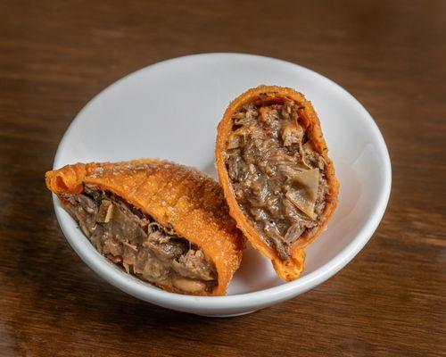 Our #1 seller: Oxtail Empanadas Slow-cooked, tender, and wrapped in a golden crust. A must-try bite at Courts Empanadas