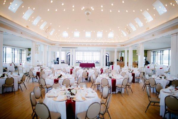 Bistro lights in the ceiling at this venue are a Client favorite to make their wedding feel more rustic and fun.