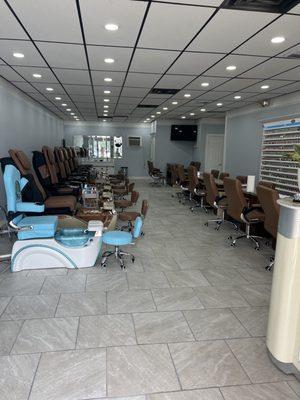Freshly renovated nail salon with modern spa chairs and manicure tables