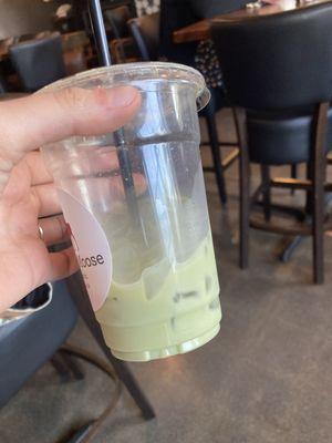 Pale green sad matcha latte with oatmilk