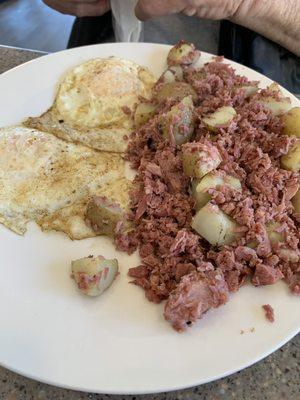 Homemade corned beef hash with over medium eggs and hashbrowns