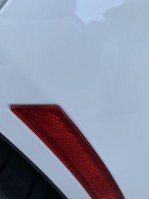 Overspray in the side marker. (I blacked them out after I left the shop)