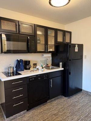 Suite has a practical kitchenette with stove full fridge dishes etc