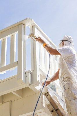 Spraying an exterior deck for a smooth finish