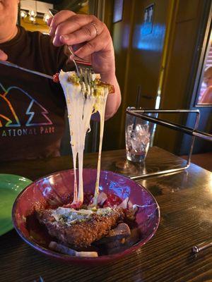 Cutting into their fried mozzarella